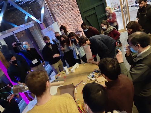 A photo of me setting up a rube goldberg machine as part of the event.