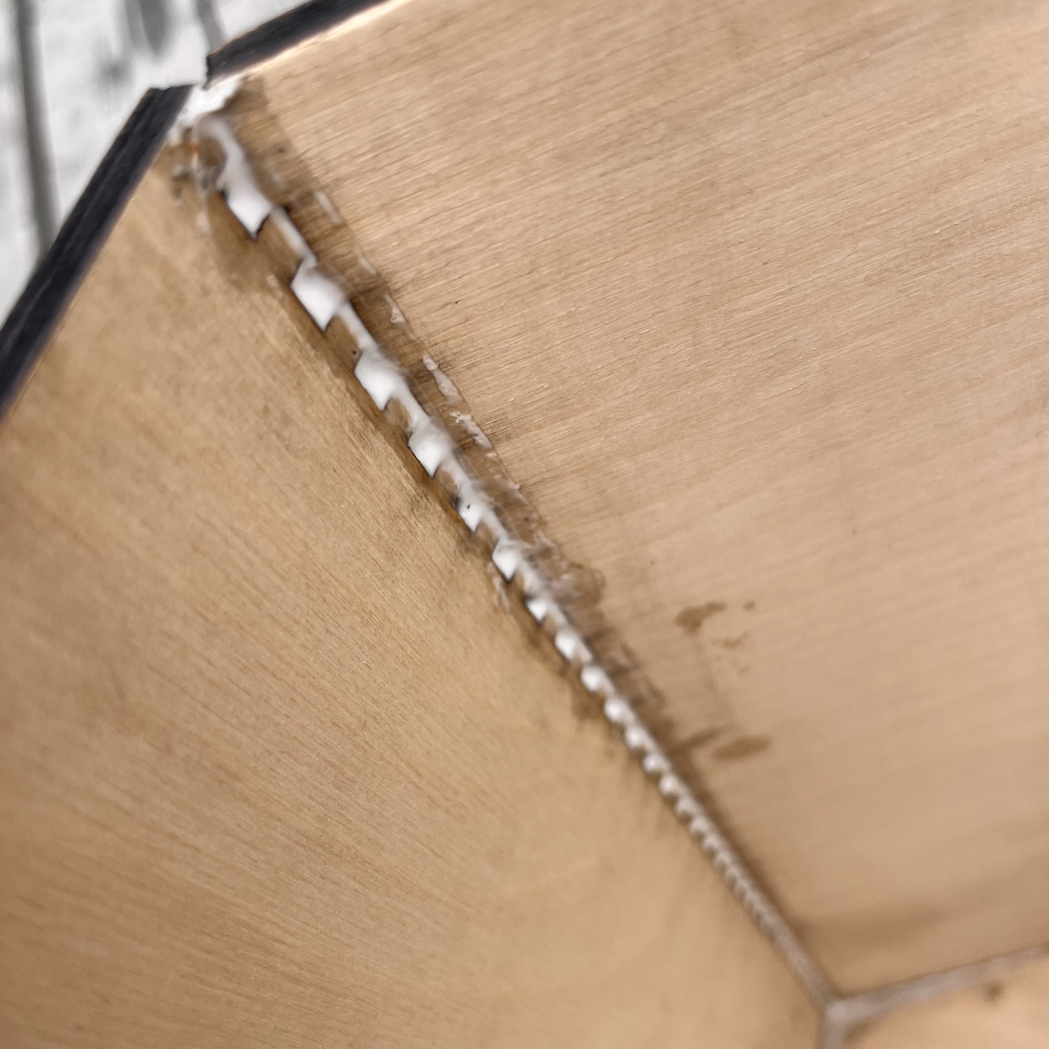 An arty shot showing the glue oozing out of the zipper like shape formed when the finger jointed parts join at 30 degrees.