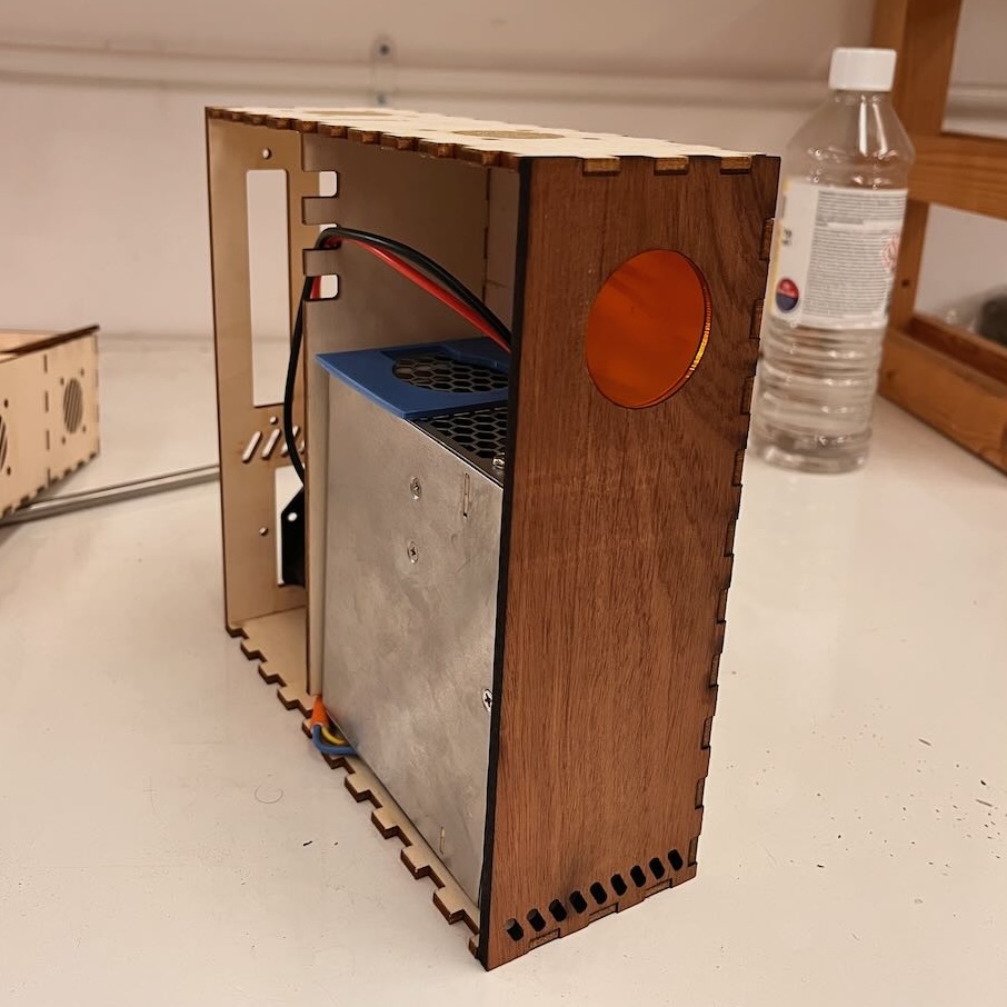 A similar image to the CAD model but this time its real life. The front panel is lasercut out of a nice piece of walnut I found somewhere and theres some orange acrylic making the screen cover.